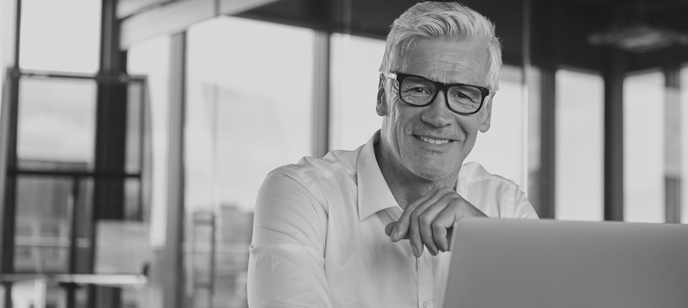 Business man with a laptop smiling