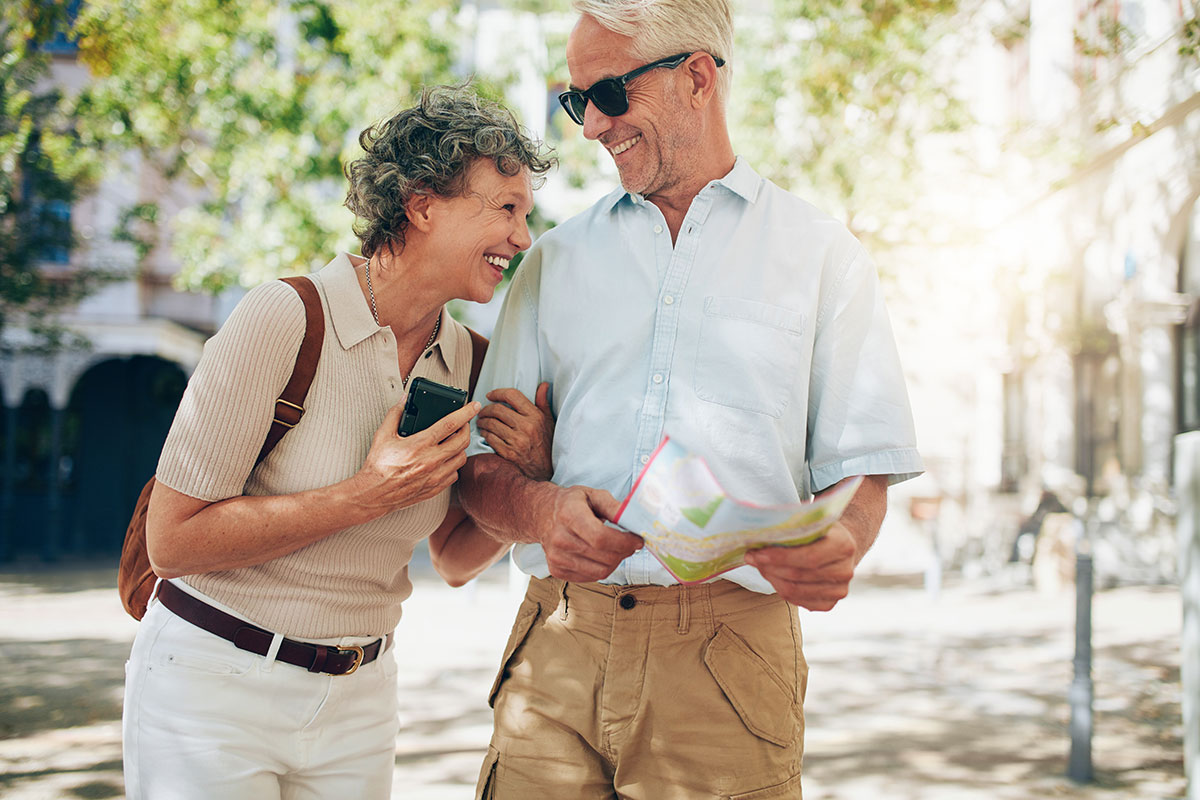Mature happy couple on holiday with a map
