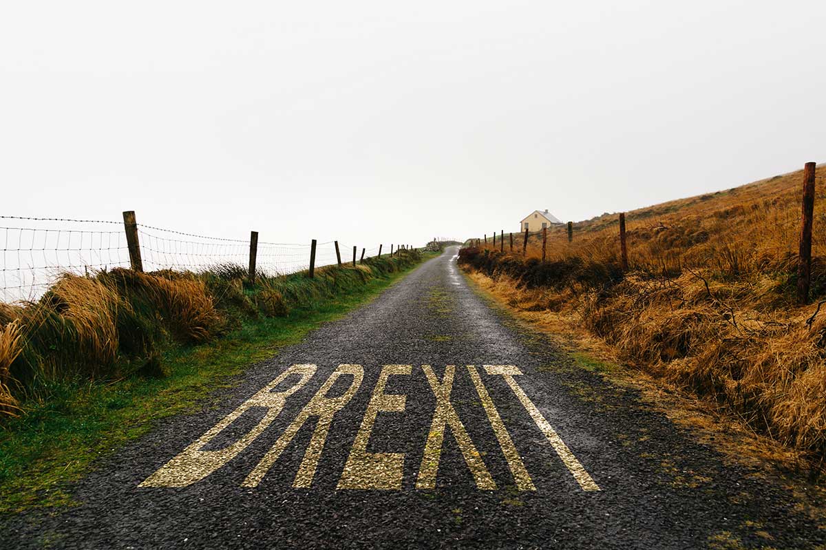 Small UK road with Brexit written on the asphalt
