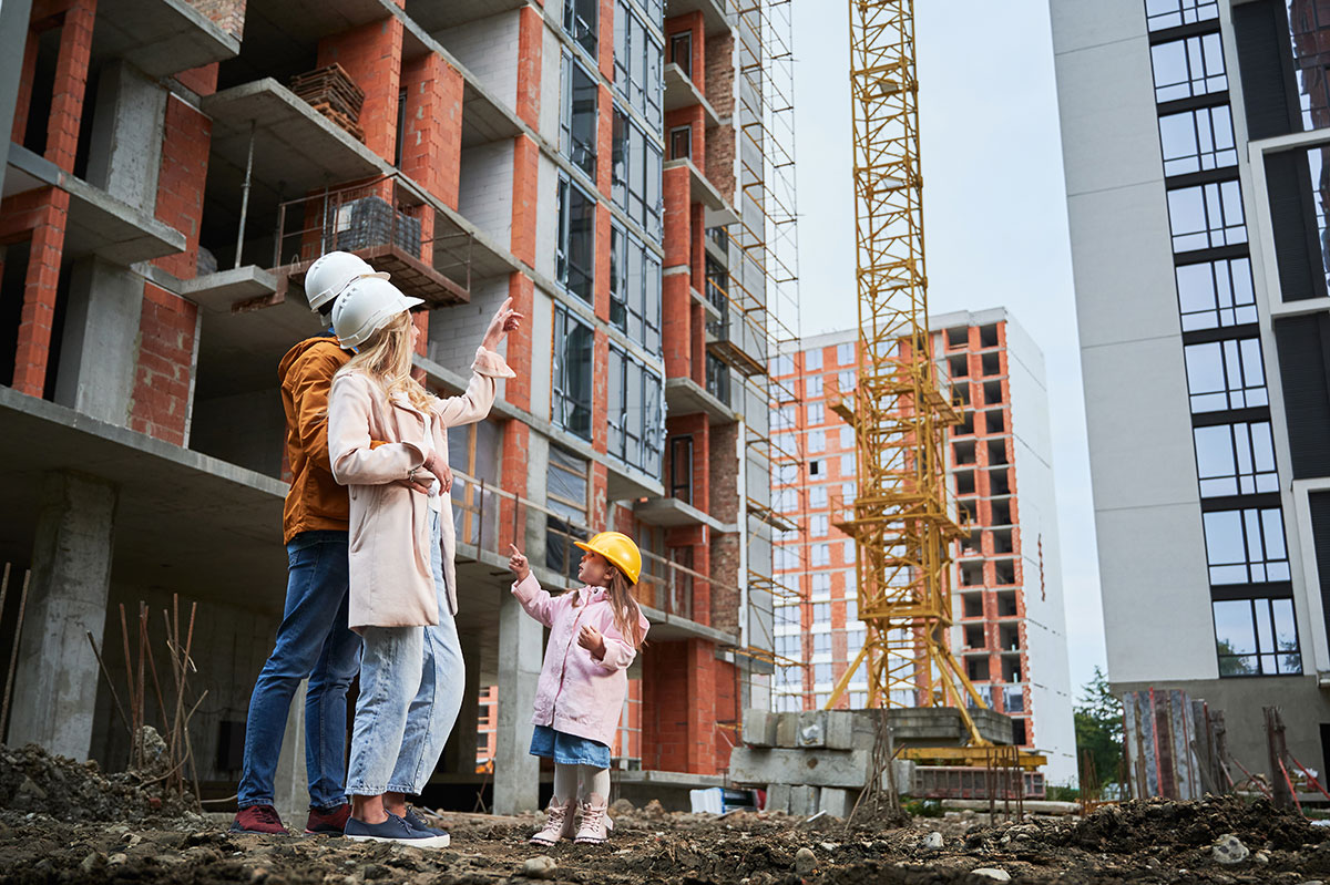Couple with a child on a construction site