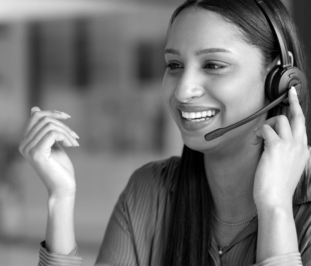 Happy young woman talking to a customer