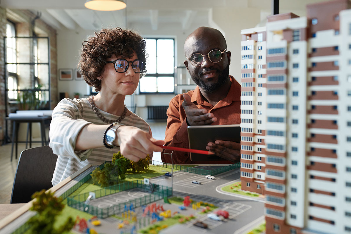 Man and woman looking at a model of a new construction
